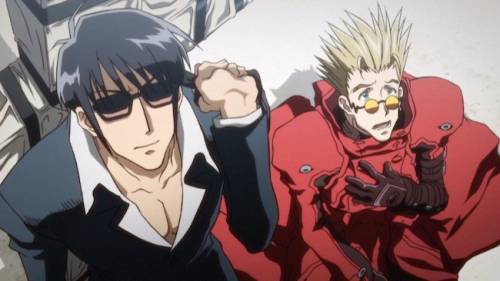 Nicholas D. Wolfwood wearing sunglasses, Vash the Stampede with hand on chest, Trigun: Badlands Rumble