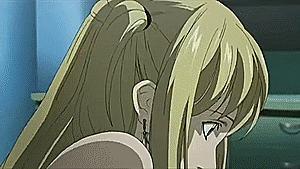Light hugs Misa Amane as she sits on her knees on the floor in episode 13